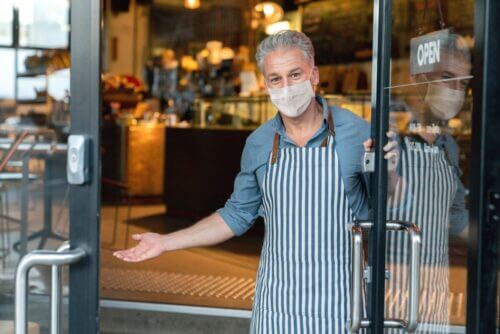 Restaurant Owner Standing in front of Open Restaurant