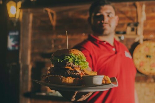 Server Delivering Hamburger on Tray